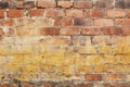 Old and weathered grungy yellow and red brick wall as seamless pattern texture background Royalty Free Stock Photo