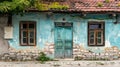 Old weathered house with blue peeling paint and a teal wooden door Royalty Free Stock Photo