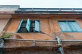 Old weathered House with Orange wall and brick and open blue pastel window. architecture, classic home Royalty Free Stock Photo