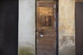 Old weathered locked wooden door with padlock