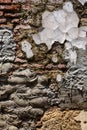 Old weathered masonry wall with crumbling brick and many cement patches, as a textured background Royalty Free Stock Photo