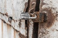 Old weathered metal door with lock closed exit entrance, worn iron close up