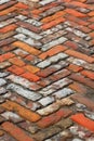 Old weathered orange brick pavement downtown, close up background texture, perspective view Royalty Free Stock Photo