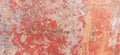 Old weathered painted wall background texture. Red dirty peeled plaster wall with falling off flakes of paint. Royalty Free Stock Photo