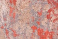 Old weathered painted wall background texture. Red dirty peeled plaster wall with falling off flakes of paint. Royalty Free Stock Photo
