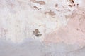 Old weathered painted wall background texture. White dirty peeled plaster wall with falling off flakes of paint. Royalty Free Stock Photo