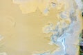 Old weathered painted wall background texture. Yellow dirty peeled plaster wall with falling off flakes of paint. Royalty Free Stock Photo