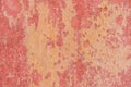 Old weathered painted wall background texture. Red dirty peeled plaster wall with falling off flakes of paint. Royalty Free Stock Photo