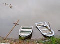 Old weathered plastic fade out color boats on smooth water surface Royalty Free Stock Photo