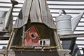 Old weathered red barn birdhouse and water sprinklers Royalty Free Stock Photo