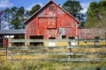 Old weathered Red Barn with Split-rail Fence in forefront Royalty Free Stock Photo