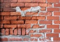 Old weathered red brick wall with obvious signs of disrepair Royalty Free Stock Photo