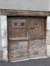 Old and weathered rustic wooden barn doors with rusty lock on ancient wood garage door house