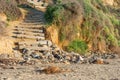 Old weathered stair case made from wooden logs leading to the beach Royalty Free Stock Photo