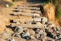 Old weathered stairs made from wooden logs leading to the beach Royalty Free Stock Photo