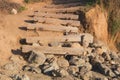 Old weathered stairs made from wooden logs leading to the beach Royalty Free Stock Photo