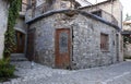 Old weathered stone house with red door and balcony in traditional village Royalty Free Stock Photo