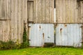 Old weathered, vine covered barn, with abandoned tires.