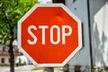 Old, weathered and violated stop sign in the street