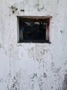Old weathered wall with small Window Royalty Free Stock Photo