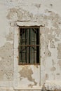 Weathered Wall With Barred Window and Shutters Royalty Free Stock Photo