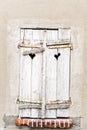 Old weathered gray shutters windows with heart shaped holes in ancient wall Royalty Free Stock Photo