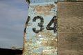 Old weathered wooden board with painted numbers