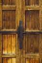 Old weathered wooden door with iron hinges and handle Royalty Free Stock Photo