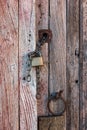 Old and weathered wooden door with the metal doorknob and he lock Royalty Free Stock Photo