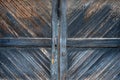 Old weathered wooden doors in diagonal pattern blue and bare wood