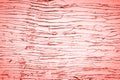 Old weathered wooden plank painted in living coral, pink color with metal strip, wooden texture wall background Royalty Free Stock Photo