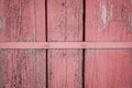 Old weathered wooden plank painted in living coral, pink color with metal strip, wooden texture wall background Royalty Free Stock Photo