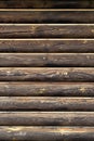 Old weathered wooden texture. Log house vertical background with copy space. Dark brown burnt wood. Royalty Free Stock Photo