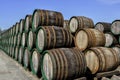 Old weathered wooden wine barrels stacked outdoors Royalty Free Stock Photo