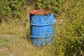 Old weathered and worn blue oil barrel in nature Royalty Free Stock Photo