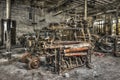 Old weaving looms and spinning machinery at an abandoned textile factory Royalty Free Stock Photo