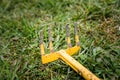 Old weeding tool or rake with missing branch abandoned lying in Royalty Free Stock Photo