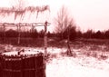 An old well on the background of a snow-covered forest. Royalty Free Stock Photo