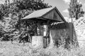 Old well with iron bucket on long forged chain for clean drinking water Royalty Free Stock Photo