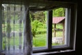 Old well seen through a rustic window Royalty Free Stock Photo