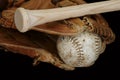 Old and Used Leather Softball and Glove with a Wood Bat Royalty Free Stock Photo