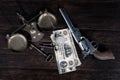 Old west Colt revolver and US banknotes and silver certificates with silver dollar coins and bronze traditional balance scale on
