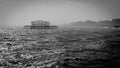 The old West Pier of Brighton, England, in rough seas on a hazy day Royalty Free Stock Photo