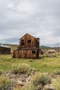 Vintage old west abandoned buildings and wagon in ghost town Bodie, California Royalty Free Stock Photo