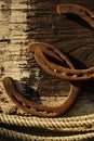 Rusted horseshoes on wooden texture background Royalty Free Stock Photo