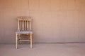 Old western chair against an adobe wall Royalty Free Stock Photo