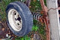 An old wheel with a rusty spring on a cart in the yard Royalty Free Stock Photo