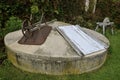 Old wheelbarrow rests on lid of water reservoir