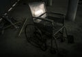 An old wheelchair in old room. old wheelchair was forsaken. this is lonely and scary concept. Royalty Free Stock Photo