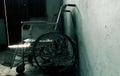 An old wheelchair in old room. old wheelchair was forsaken. Royalty Free Stock Photo